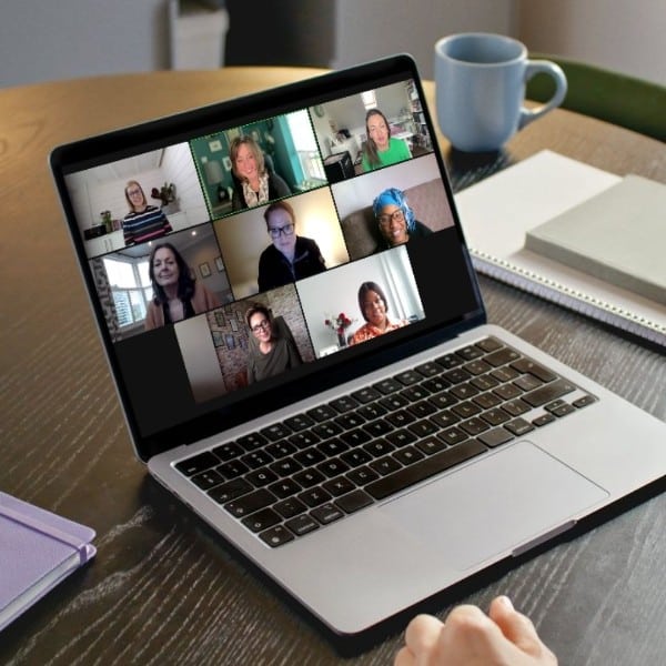 Laptop screen showing students in a live Zoom session for accredited Health & Wellbeing Coach Training.